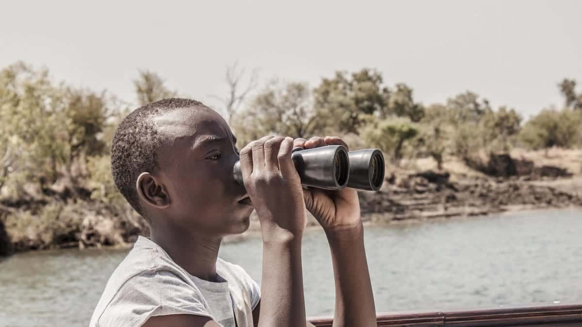 focus,  look beyond,  river,  binoculars,  look,  observation,  search,  watching,  distance,  outdoors,  tourist,  looking,  nature,  person,  water,  boy,  holding