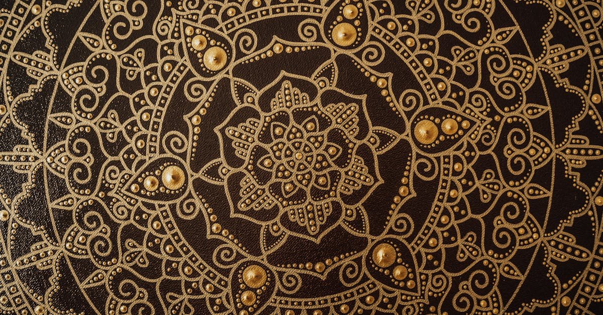 Close-up of an intricate gold mandala pattern on a dark canvas, showcasing detailed artistry via Pexels