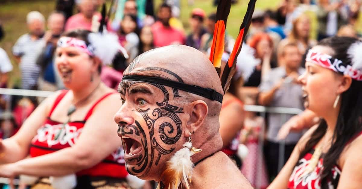An energetic Maori performer with a painted face during a tribal festival in daylight via Pexels