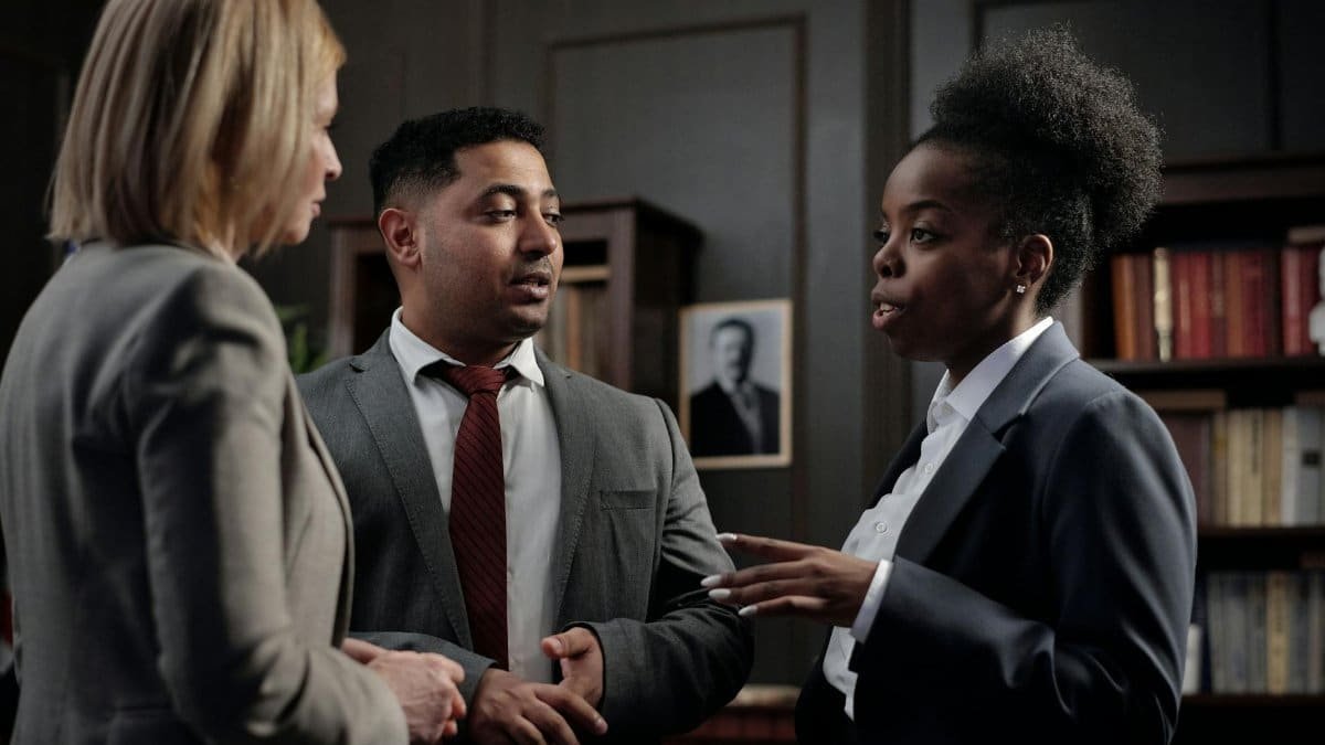 Diverse professionals engaged in strategic discussion in a law office setting.