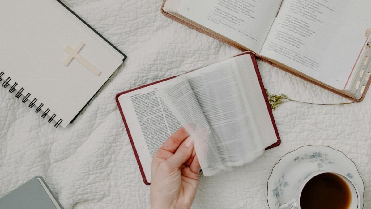 A cozy setup of Bible reading with a cup of coffee, evoking a peaceful morning routine.