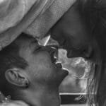 Intimate black and white portrait of a couple sharing a tender moment, evoking love and connection.