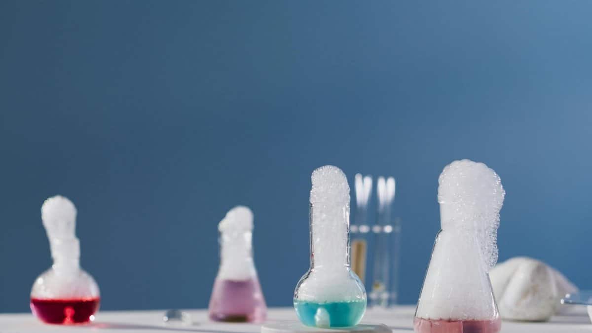 Vibrant chemical reactions in flasks with bubbles in a lab setting.