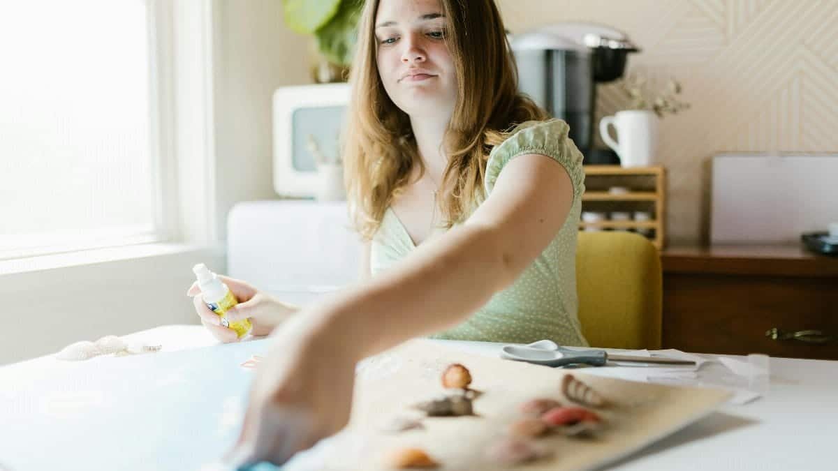 Teen girl enjoying a relaxing indoor crafting activity with focus on creativity and enjoyment.