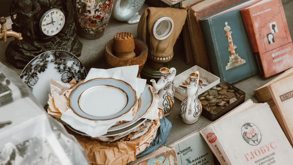 A collection of vintage books, ceramics, and antiques displayed in a nostalgic setting.