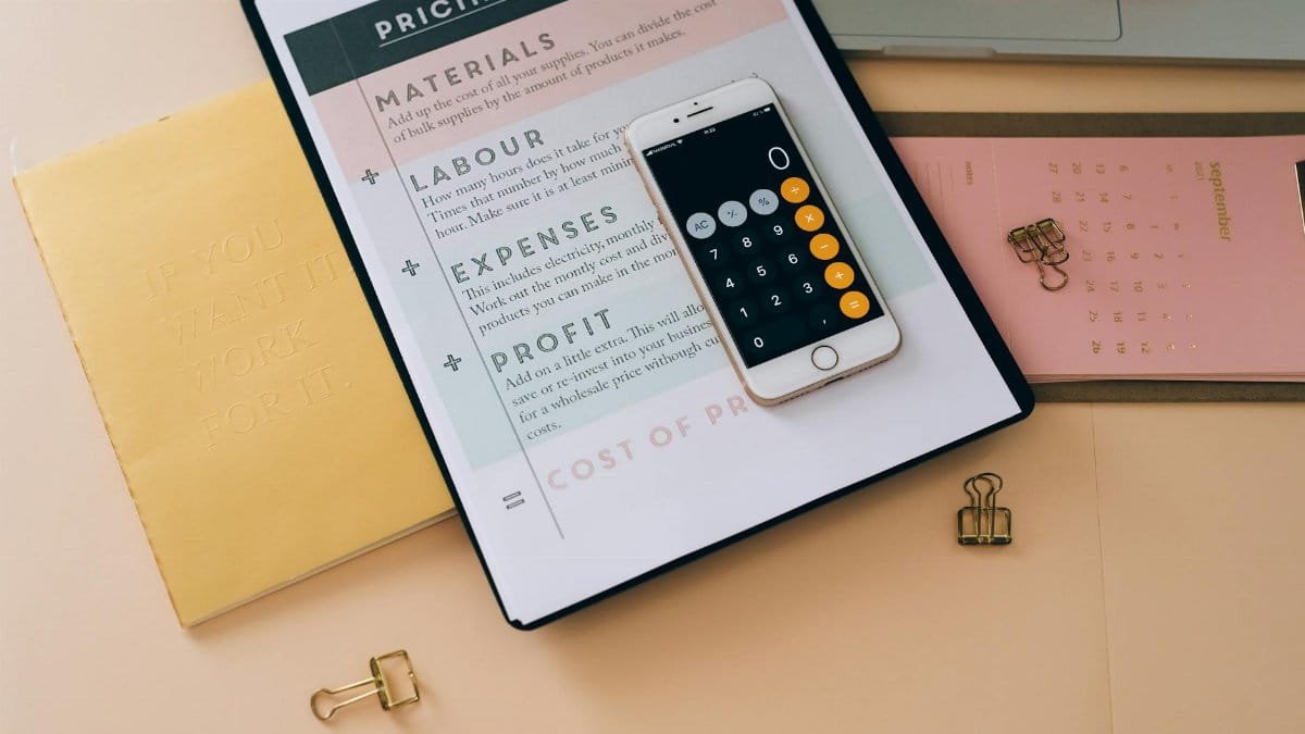 Organized business tools with a smartphone, documents, and stationery in a flat lay format.