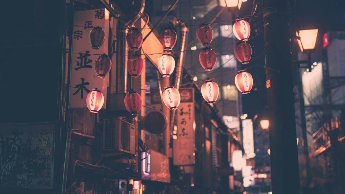 Moody night street with red lanterns in Tokyo Japan, capturing urban charm and cultural essence.