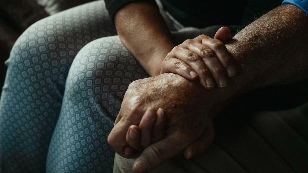 A close-up of hands conveying support and compassion in an intimate moment.