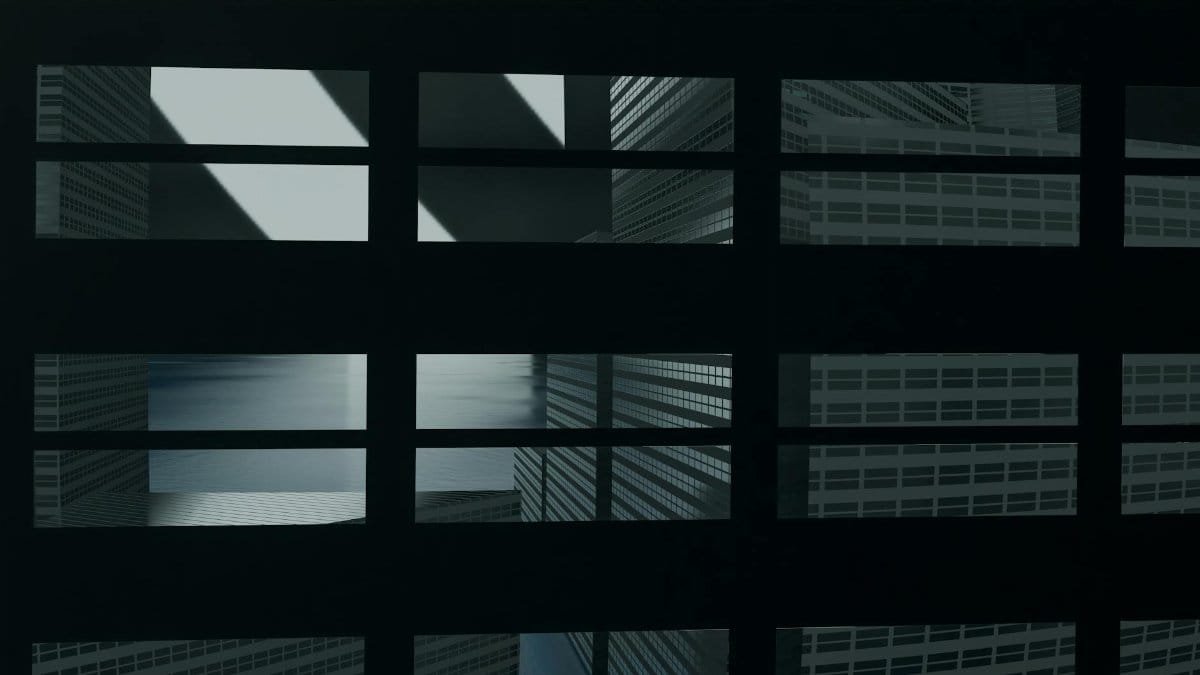 Abstract view of skyscrapers captured through window grids, creating a digital art ambiance.