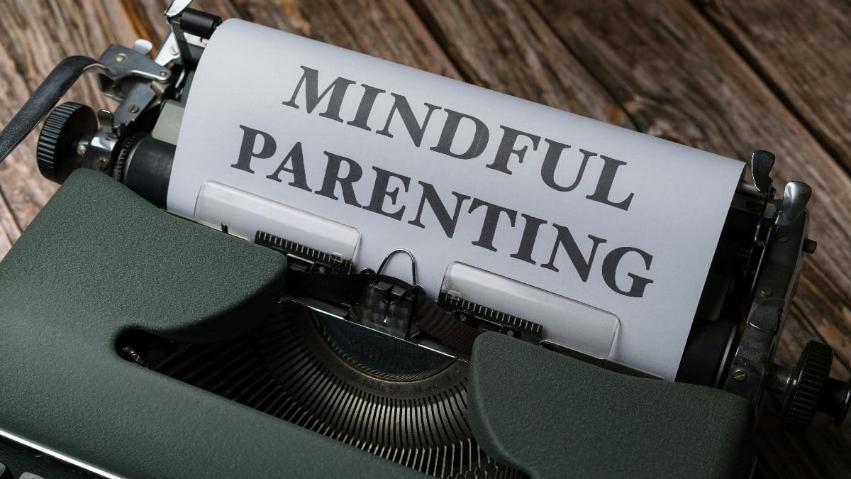 A typewriter with a paper reading 'Mindful Parenting' on a wooden surface. via Pexels