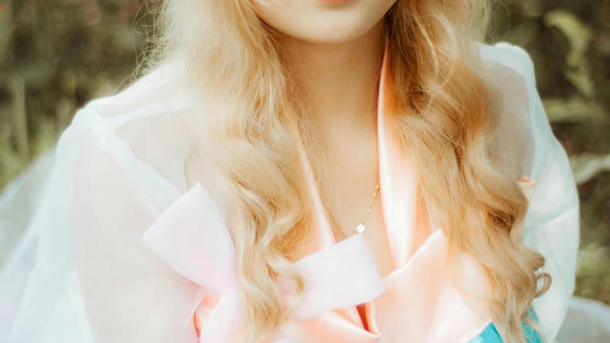 A captivating portrait of a woman in elegant elven cosplay with a crown, captured outdoors.