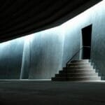 Minimalist view of the Sancaklar Mosque entrance emphasizing modern architecture and lighting.