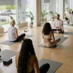 A diverse group practicing yoga indoors on mats, fostering mindfulness and health.