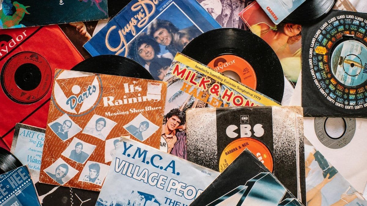 A flat lay of vintage vinyl record covers showcasing 70s and 80s music nostalgia.