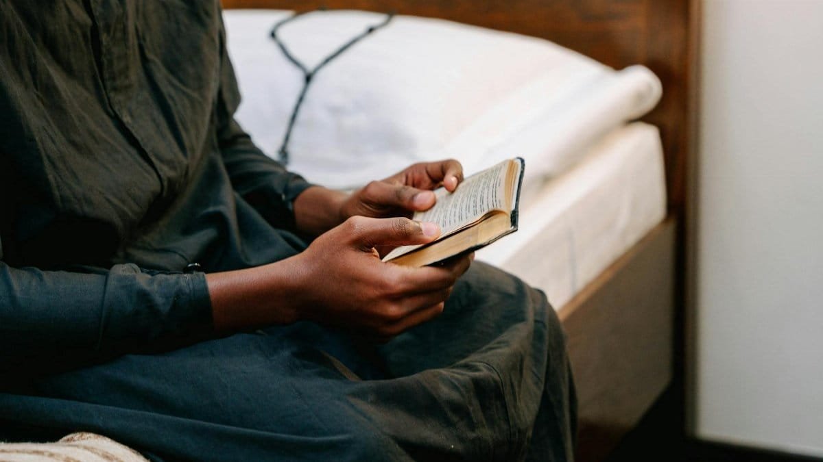 Close-up of an individual reading a book, symbolizing faith and reflection.