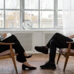 A therapist engaging in a counseling session with a male patient to support mental health. via Pexels