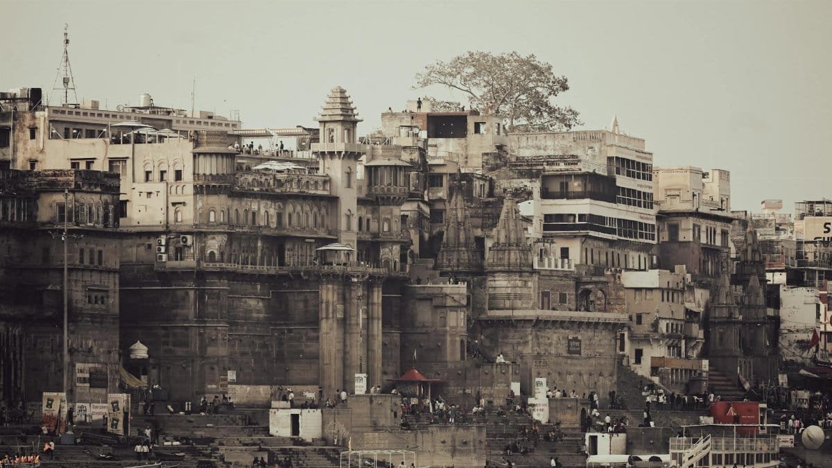 Vintage view of Varanasi's iconic riverfront architecture along the Ganges River, a popular tourist destination in India.