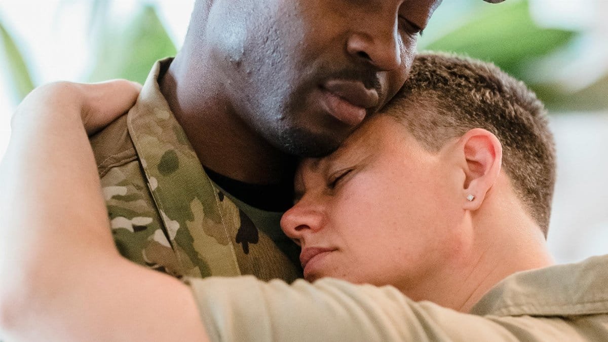 Tender moment of a soldier embracing a loved one, showcasing deep emotional connection.