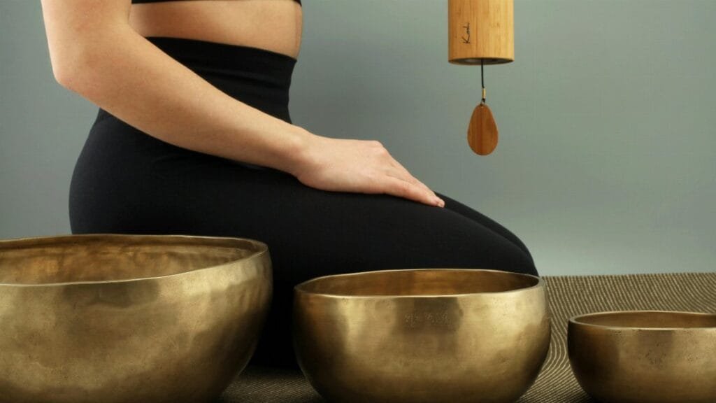A tranquil scene featuring meditation with Tibetan singing bowls for relaxation and healing.