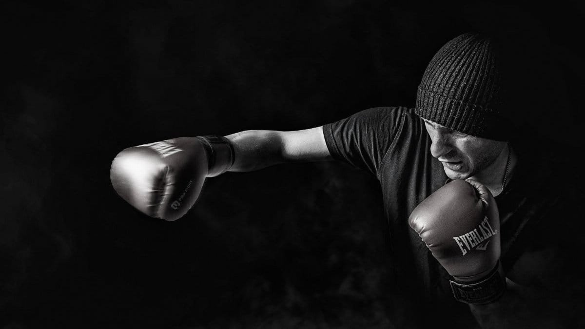 A powerful black and white image of a boxer throwing a punch, showcasing strength and focus.