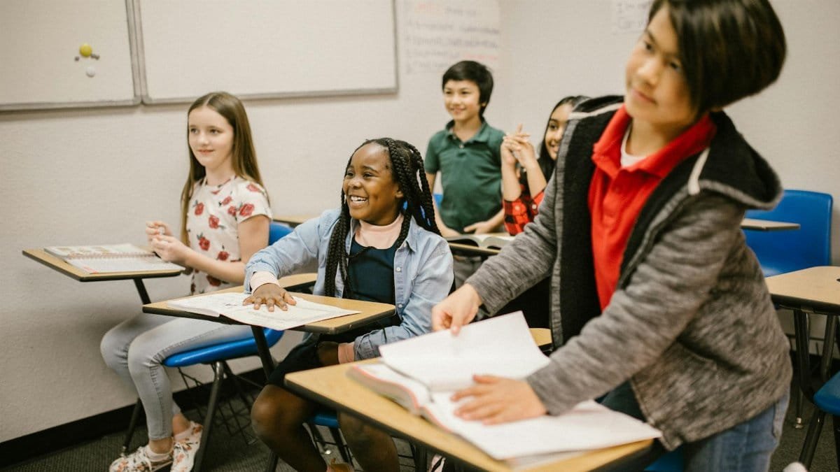 A group of diverse students actively participating in a classroom setting, promoting inclusivity and learning.