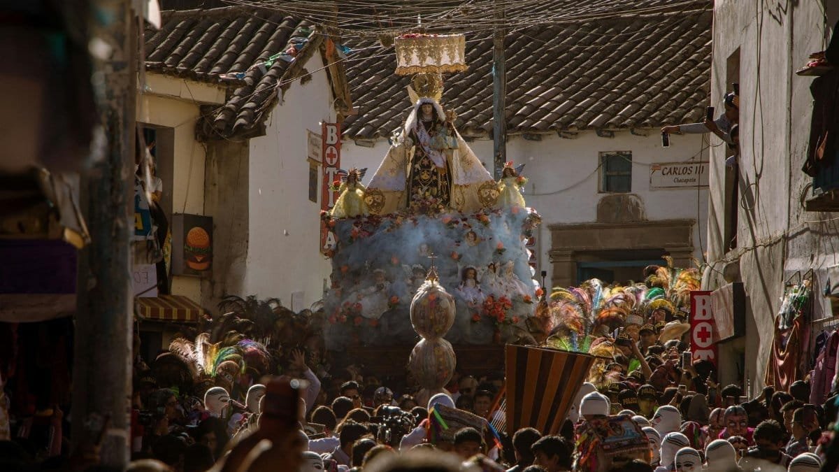 A colorful religious procession in Cusco, Peru, showcasing local culture and tradition.