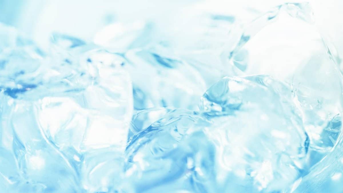 Abstract close-up of ice cubes against a bright blue background, capturing the essence of freshness.