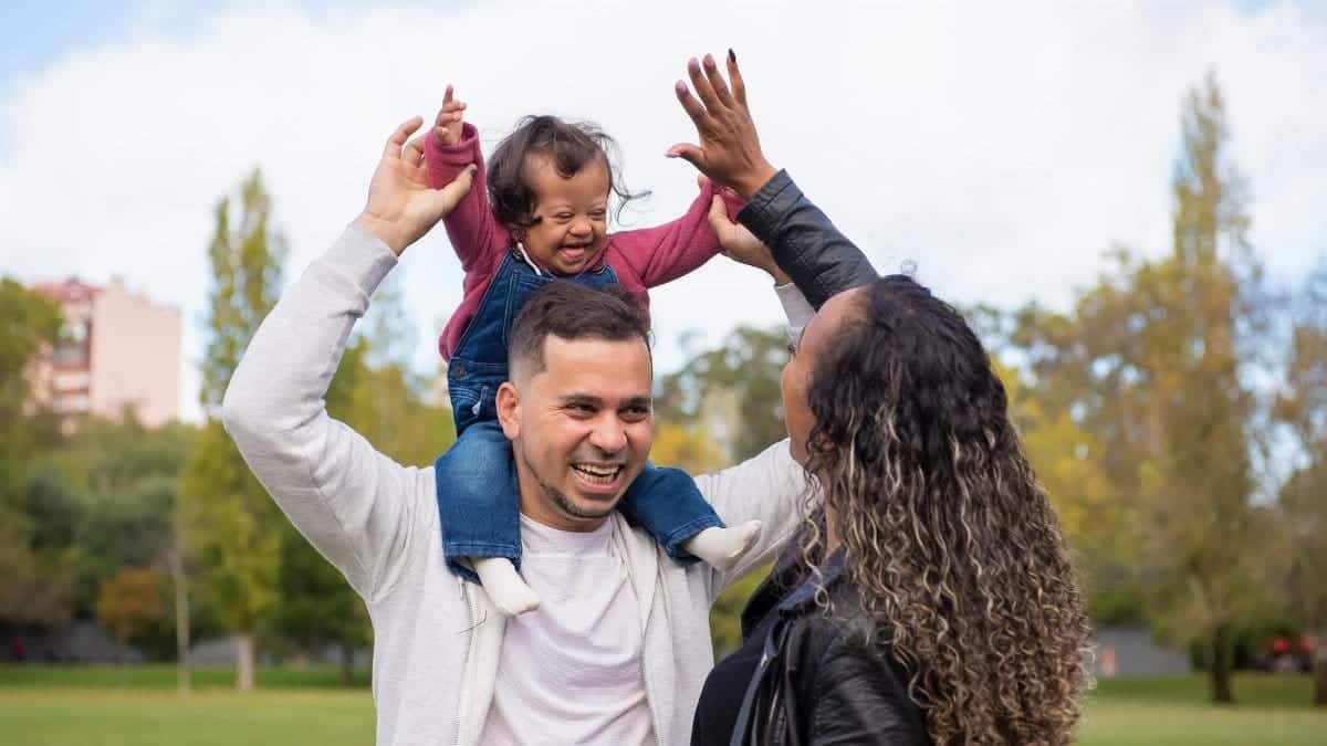 Happy family enjoying quality time outdoors in a sunny park setting.