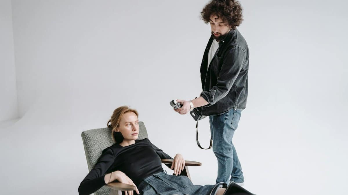 Photographer instructing model during a professional studio photoshoot.
