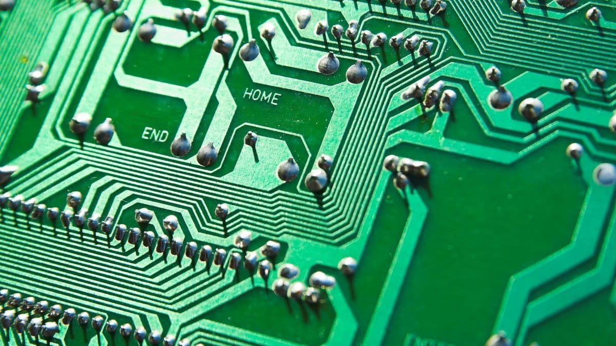 Detailed view of green circuit board with visible chips and pathways, highlighting technology elements.
