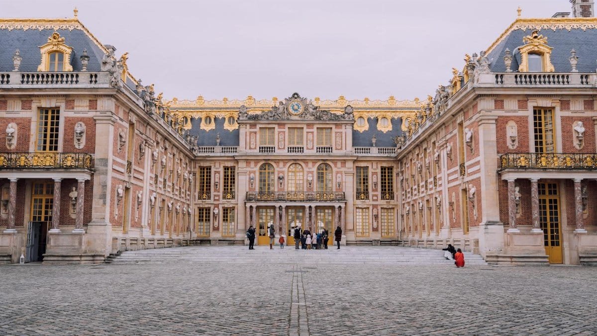 Majestic view of the Palace of Versailles courtyard showcasing its classic architecture.