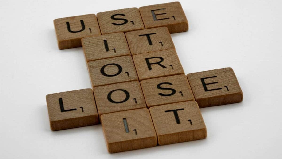 Arrangement of scrabble tiles spelling 'use it or lose it', encouraging motivation and creativity.