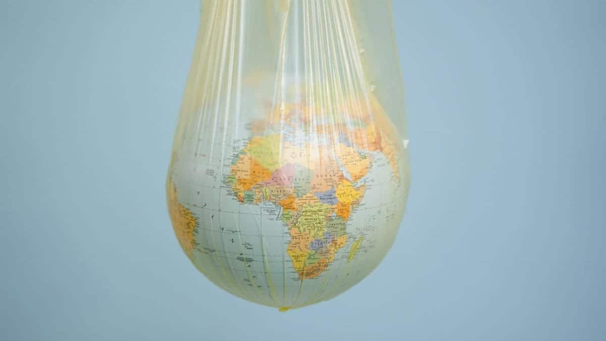 A globe wrapped in plastic highlighting global environmental issues.