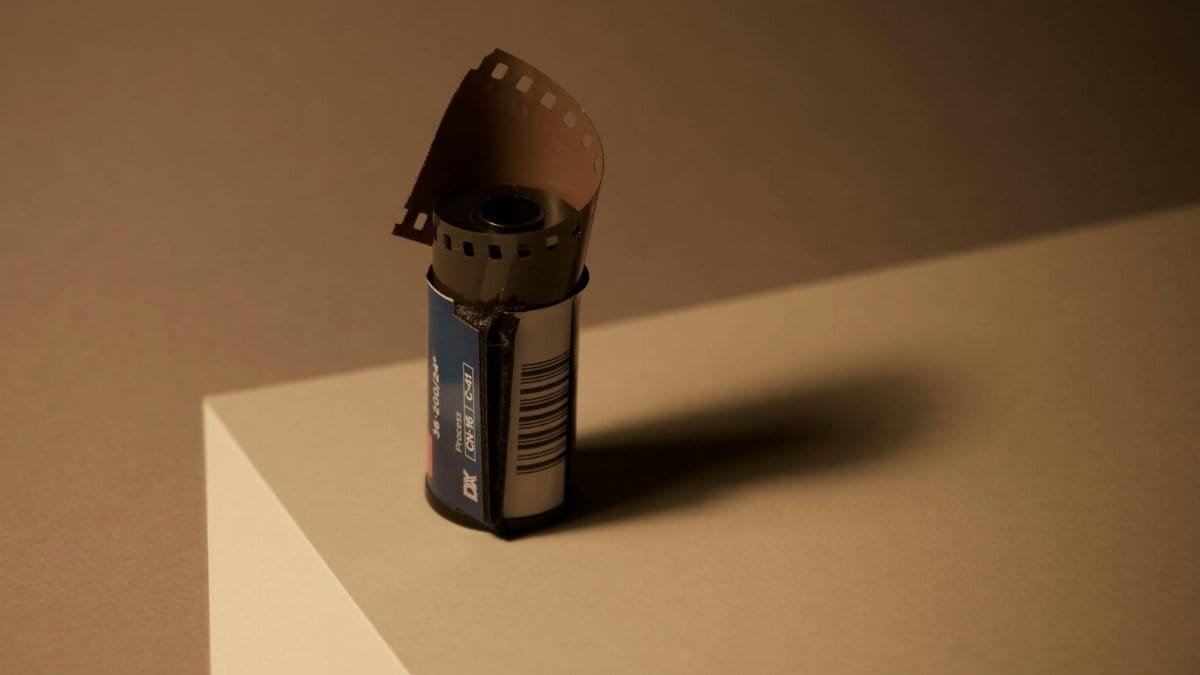 A film roll on a geometric surface, capturing the essence of analog photography.