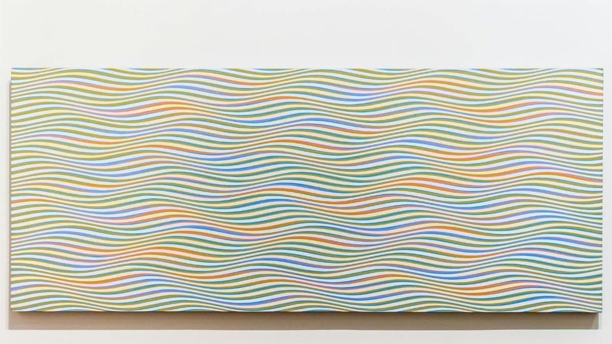 Colorful abstract wave pattern painting on a wall, perfect decor piece.