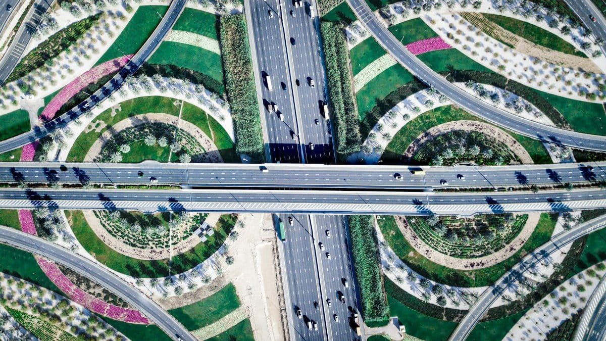 A modern intersection in Dubai showcasing unique circular garden designs and transportation network.