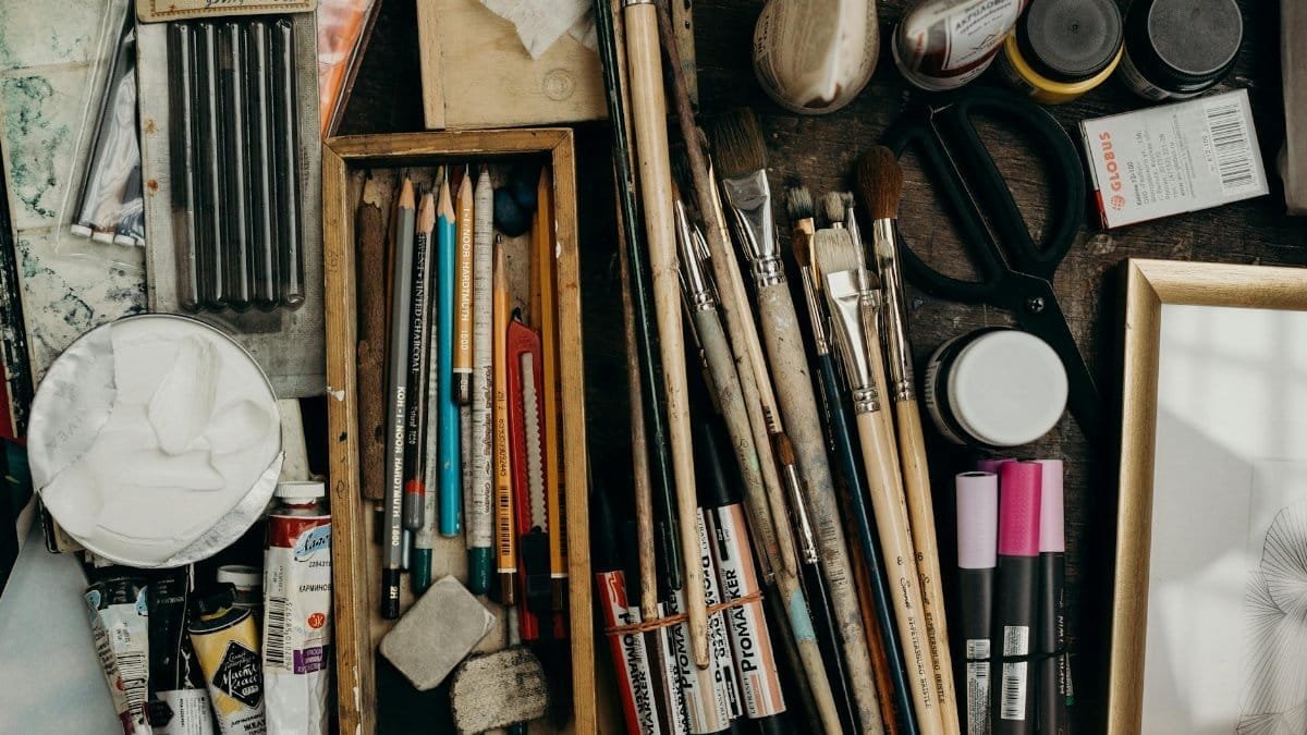 Top view of various art supplies on a desk, showcasing creativity tools.
