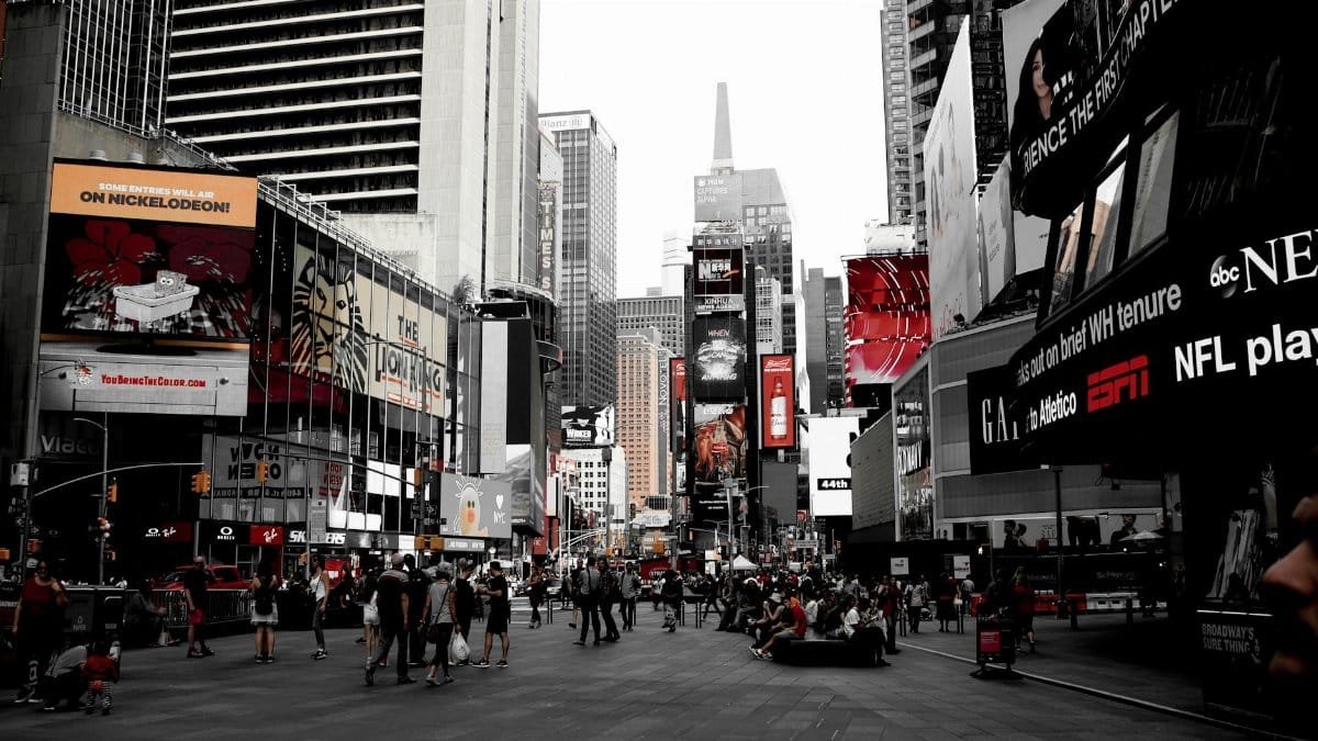 Dynamic scene of Times Square showcasing bustling urban life and iconic billboards in New York City.