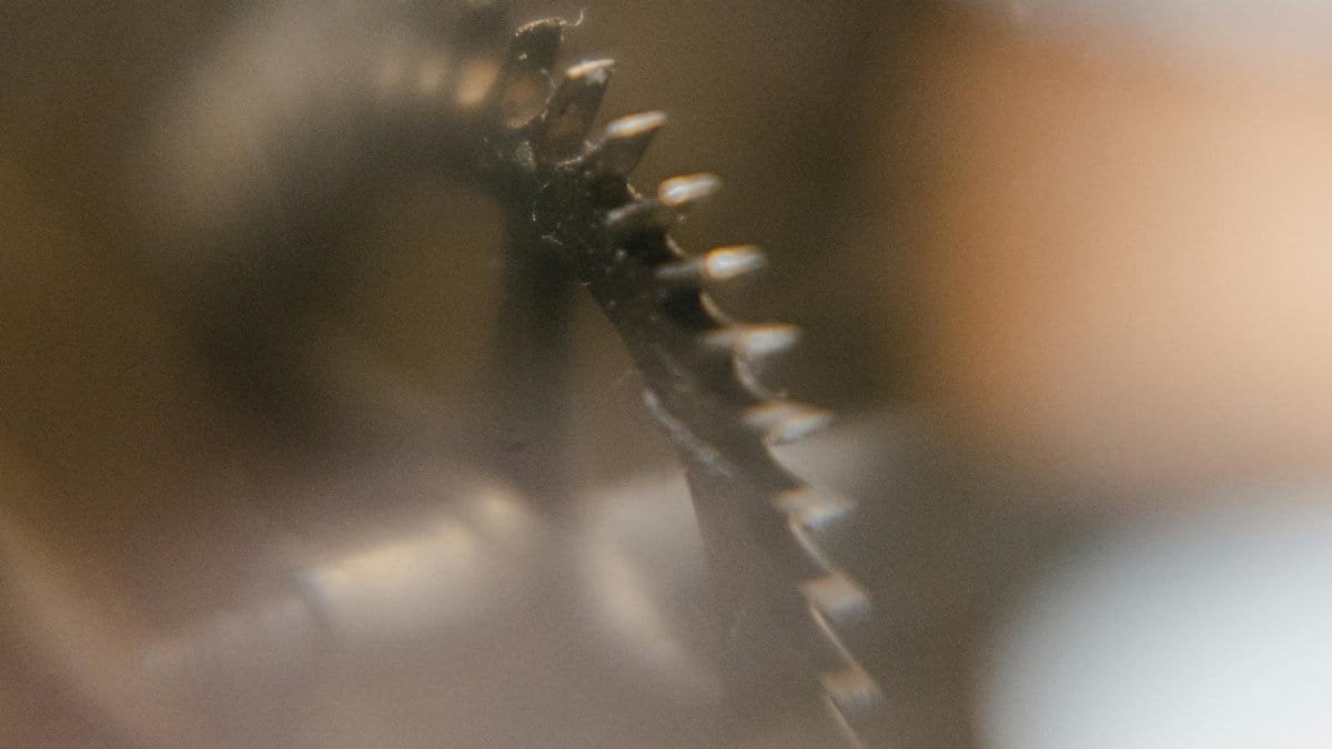 Intricate mechanical gear captured in a blurred close-up, highlighting details.