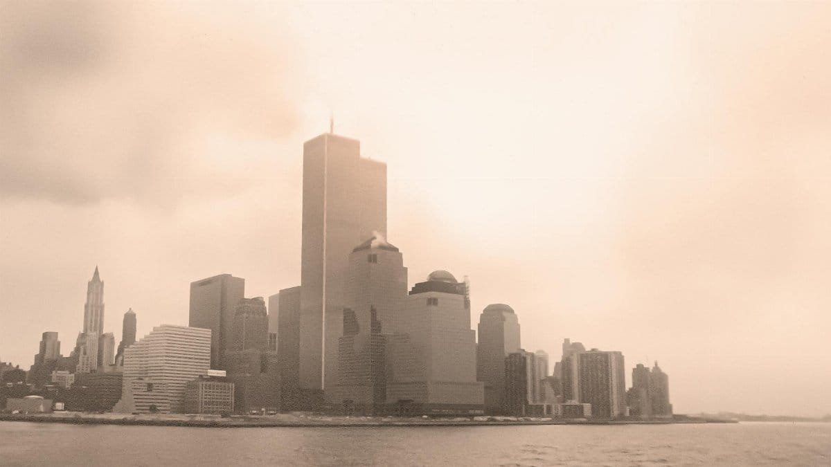 Sepia-toned view of New York City skyline with the Twin Towers on a foggy day.