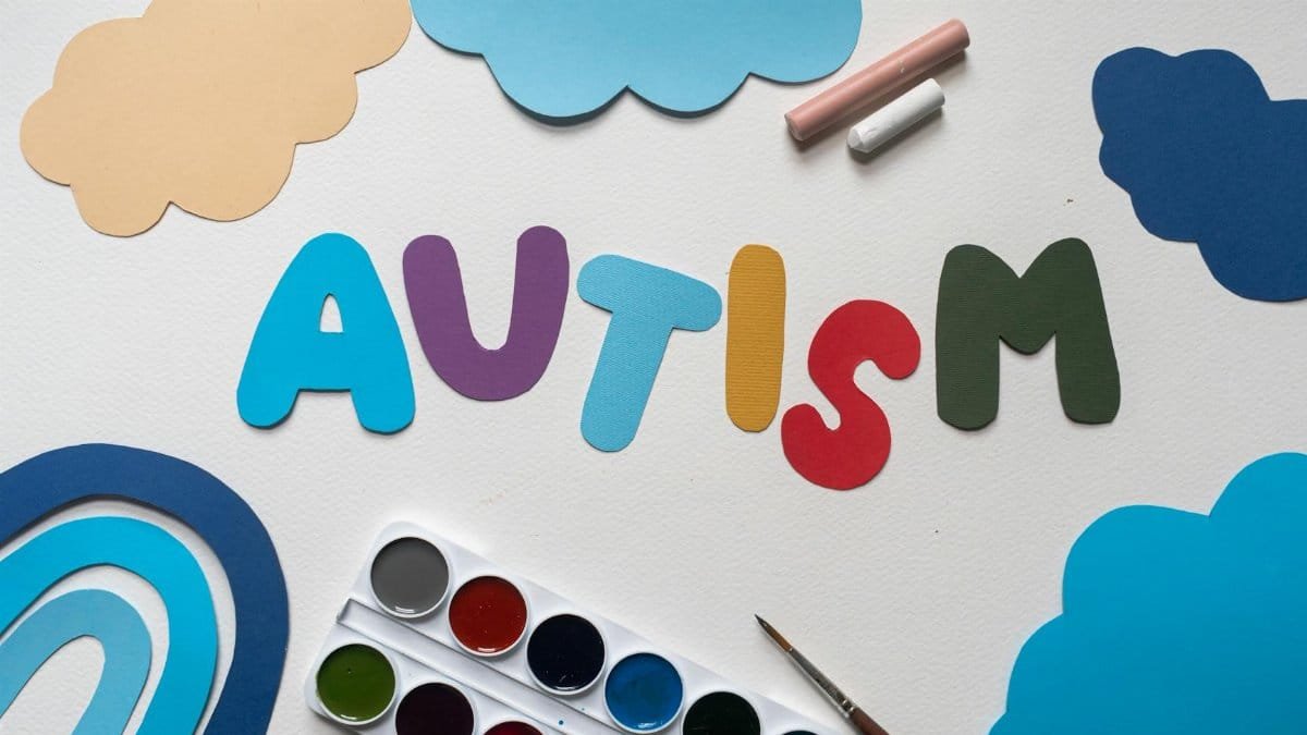 A vibrant autism awareness theme with watercolor paints and cutouts, featuring the word 'Autism'.