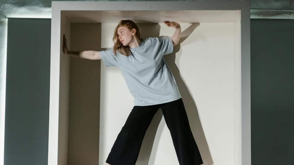 A woman trapped in a small box symbolizing claustrophobia and anxiety.