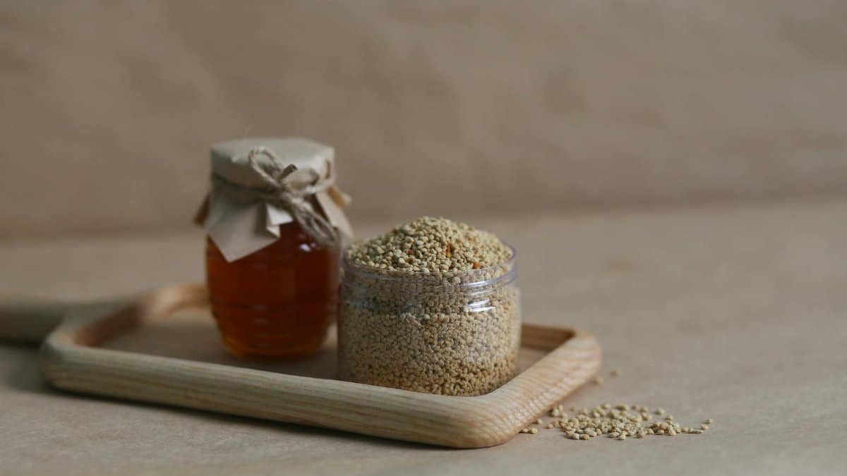 Close-up of glass jars with honey and quinoa, showcasing natural ingredients.
