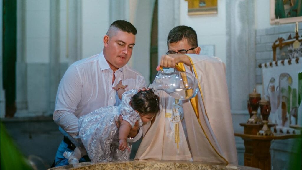 A child's baptism ceremony in a church in Santo Domingo, Ecuador.