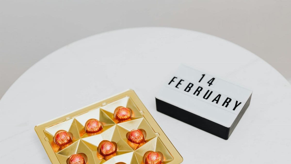 A gold box of chocolate pralines with 14 February sign, highlighting Valentine's Day.