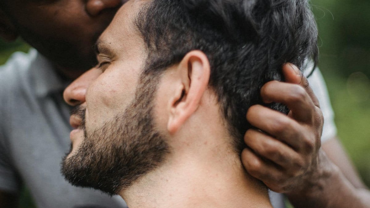 Close-up of a couple sharing an intimate moment outdoors, showcasing love and connection.