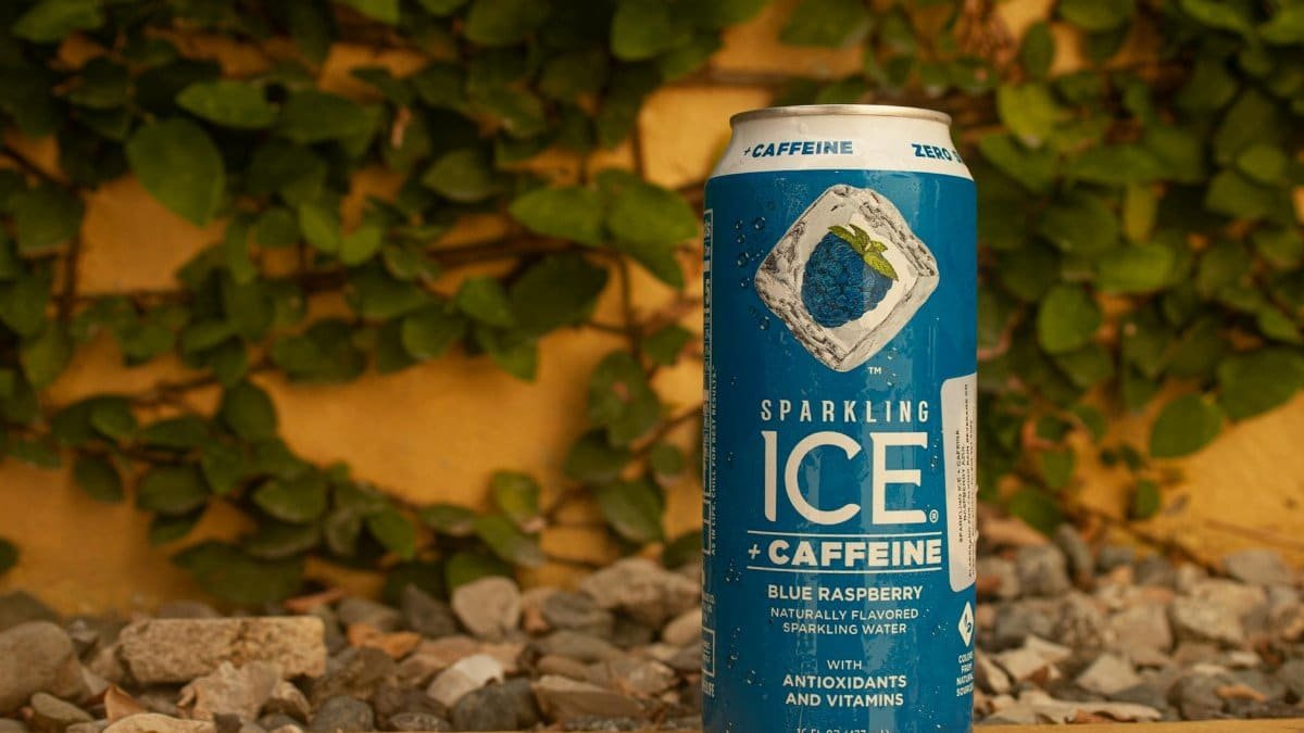 Blue Raspberry flavored sparkling water with caffeine and antioxidants in an outdoor setting.
