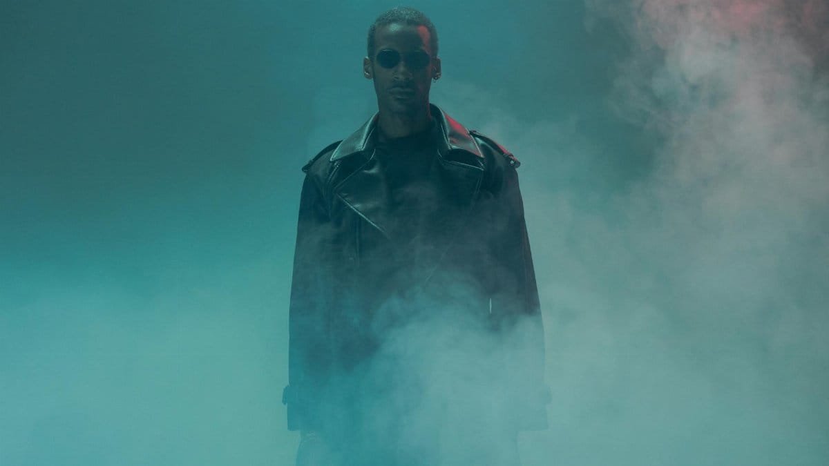 A dramatic portrait of a man in a leather jacket surrounded by smokey ambiance, exuding cyberpunk vibes.