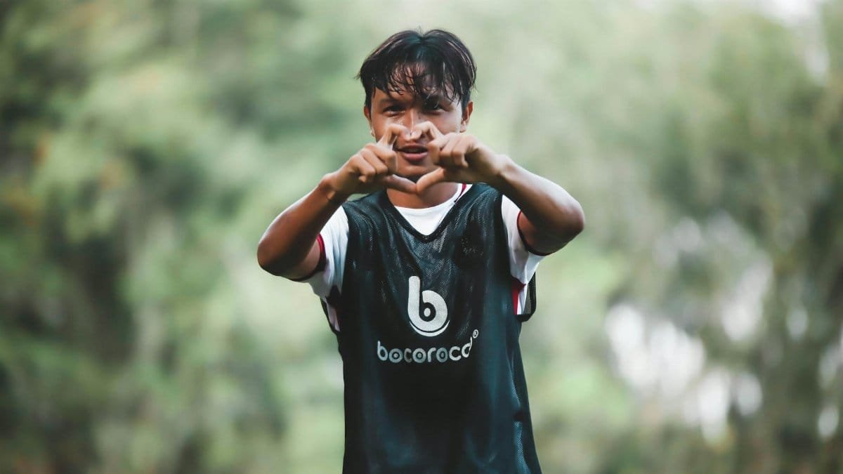 Energetic young soccer player making a gesture on the field, filled with enthusiasm and energy.