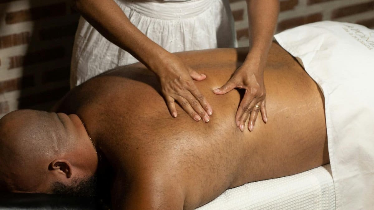A soothing massage therapy session with a professional therapist working on a client indoors.